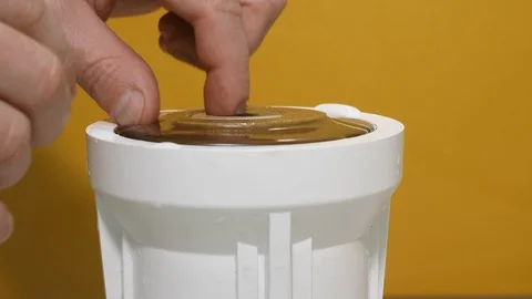 White man hands take out old drinking water purification filter on yellow Video stock 126208940