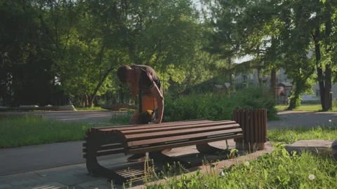 White Man Kneeling At Bench Rummaging Bag And Pockets, Deliberate Search, Tense Vídeos de archivo 324612908