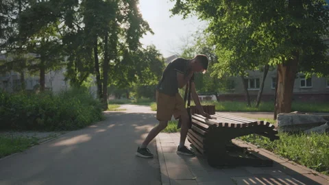 White Man Leaning Over Bench Slat To Inspect Gap, Careful Hands, Intentional Video stock 324612875
