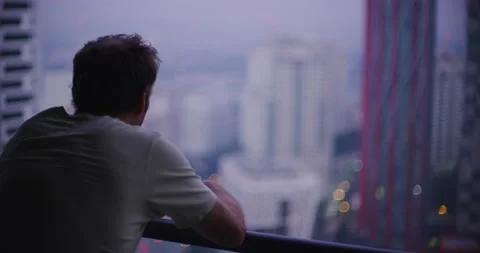 White Man Looks Out His Balcony at Empire City in Kuala Lumpur, Malaysia Stock Footage 147082091