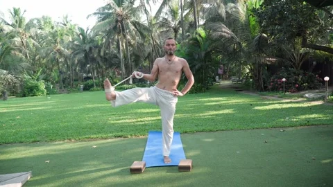 White man performing yoga posture in nature 動画素材 167970952