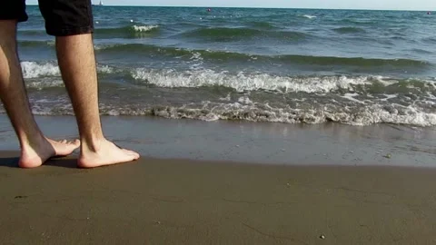 White man playing with the sea waves by going in and out into the sea water Video stock 138460242