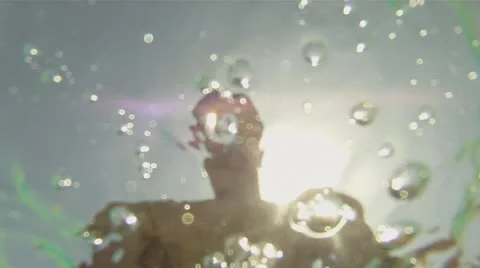 White man plays with the camera rotates it, and plunges into the water Stock Footage 11059451