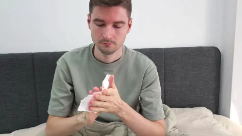 White man taking a tissue from a packet and cleaning hands with a wet wipe Stock Footage 282610120