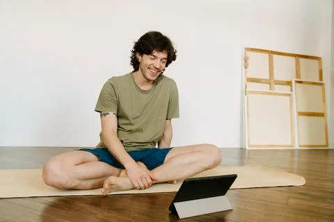 White man using tablet computer during yoga practice Foto stock