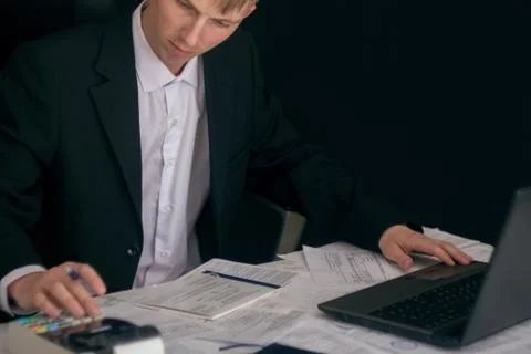 White man working in an office with documents. The Manager makes the report a Stock Photos