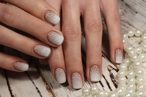 White manicure with a pattern Stock Photos