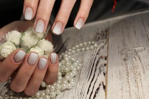 White manicure with a pattern Stock Photos