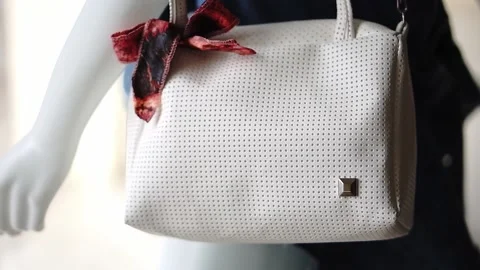 White mannequin holding a white simple bag at the clothing store. Stock Footage 153444847