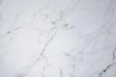 A white marble background with subtle gray veining and a natural stone textur Stock Photos