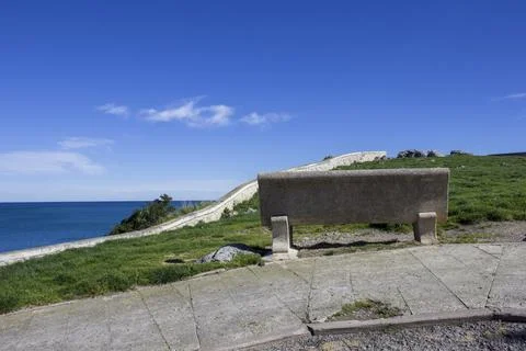 A white marble bench on a cliff overlooking the ocean Stock Photos