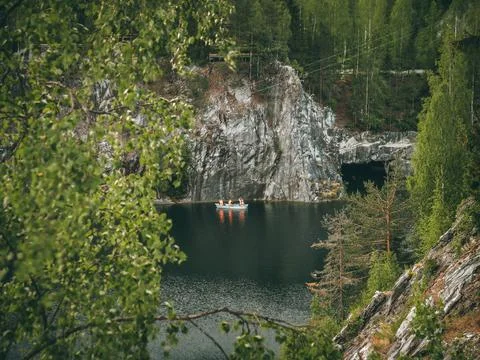 White marble canyon, inside a small lake, trees grow on the hills Stock Photos