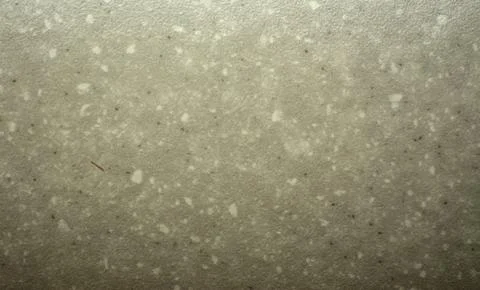 White marble chips on a solid dirty gray surface, close-up of a polished na.. Foto stock