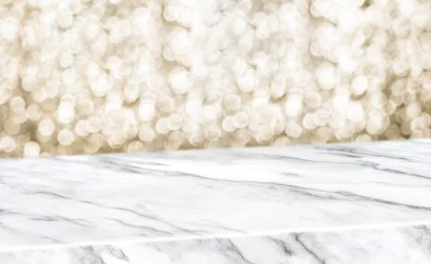 White marble glossy table diagonal with blur sparkling gold bokeh abstract ba Stock Photos