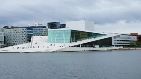 White marble slopes angular glass facade oslo opera house rise harbor people Stock Footage 327632593