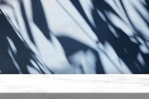 White Marble Table with Light Beam, Shadow, and Spotlight on the Blue Concr.. Stock Photos