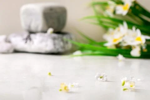 White marble table with small white flowers Stock Photos