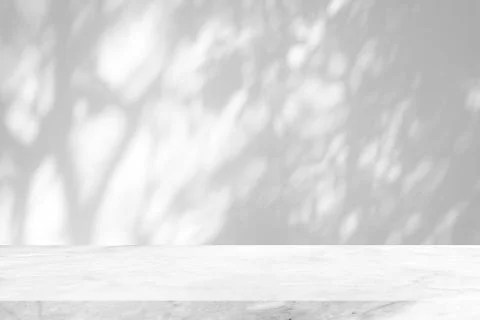 White Marble Table with Tree Shadow on Concrete Wall Texture Background. Stock Photos