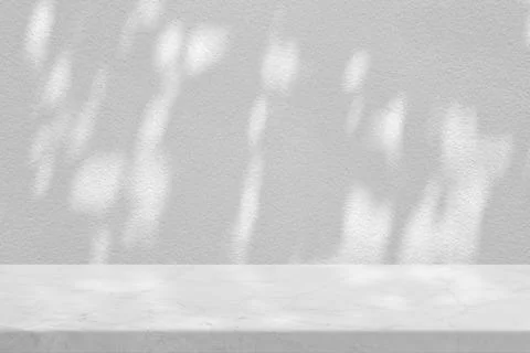 White Marble Table with Tree Shadow in the Garden on Concrete Wall Texture Ba Stock Photos
