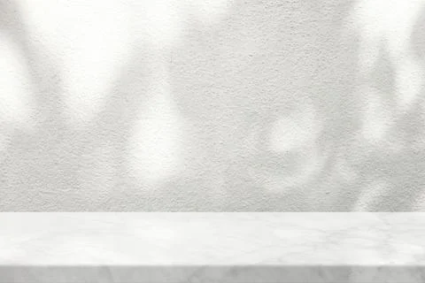 White Marble Table with Tree Shadow on Concrete Wall Texture Background Stock Photos