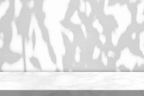 White Marble Table with Tree Shadow on Concrete Wall Texture Background Stock Photos
