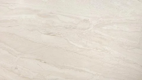 A white marble wall with a pattern of small dots. The wall is smooth and has  Stock Photos