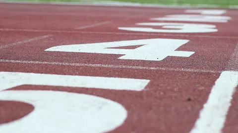 White markings on the red starting treadmill stadium seats with numbers Stock Footage 56185149