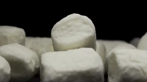 White marshmallow rotating on a black background, a handful of marshmallows. Stock Footage 151695690