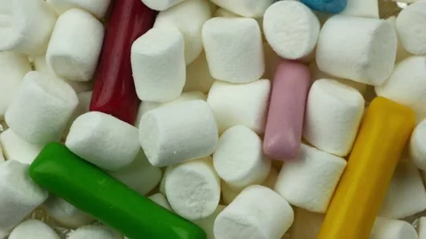 White marshmallow rotating with colored stick sweets Video stock 169817001