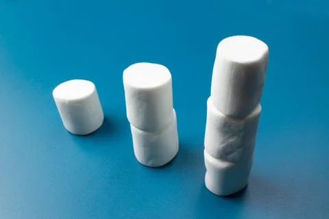 White marshmellow close up on blue background Stock Photos