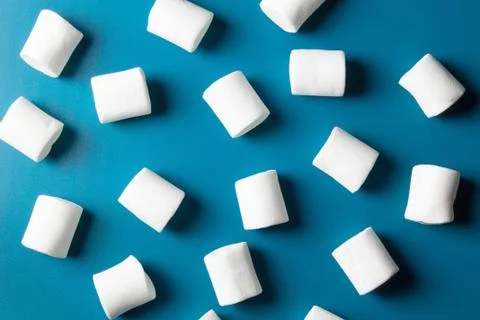 White marshmellow close up on blue background Stock Photos