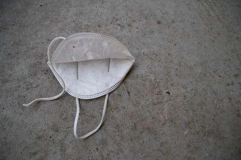 A white mask of the backside view on a gray background with copy space Stock Photos