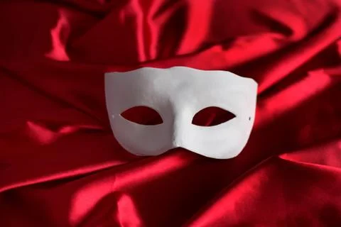 White mask on red background Stock Photos