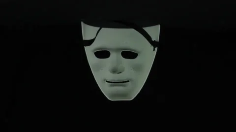 White mask rotates on a black background loop Stock Footage 34660335