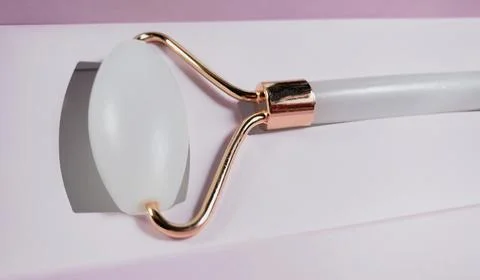 White massage quartz roller for the face close-up isolated on a white background Stock Photos