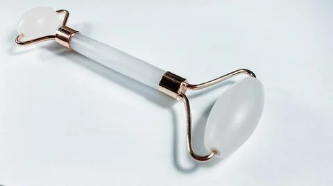 White massage quartz roller for the face close-up isolated on a white background Stock Photos