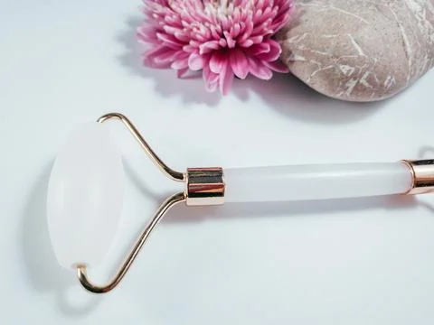 White massage quartz roller for the face close-up isolated on a white background Stock Photos