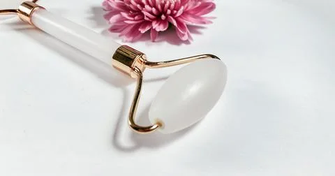 White massage quartz roller for the face close-up isolated on a white background Stock Photos