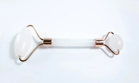 White massage quartz roller for the face close-up isolated on a white background Stock Photos