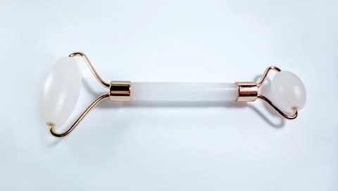 White massage quartz roller for the face close-up isolated on a white background Stock Photos