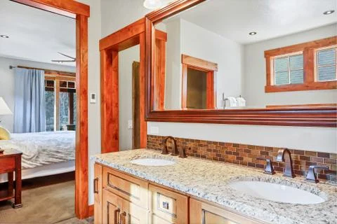 White master bathroom with dual vanity and granite counter top. Stock Photos