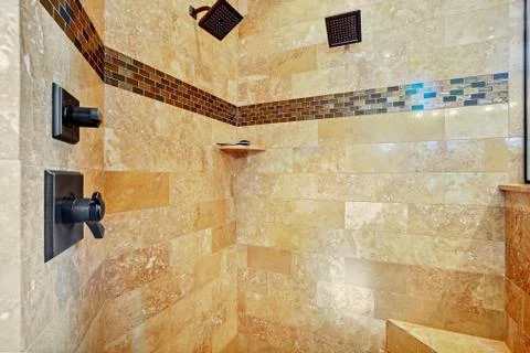 White master bathroom with large walk-in shower and stone tiled walls. Stock Photos