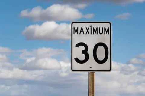 White Maximum 30 Speed Limit Road Sign On Blue Sky Background Stock Photos