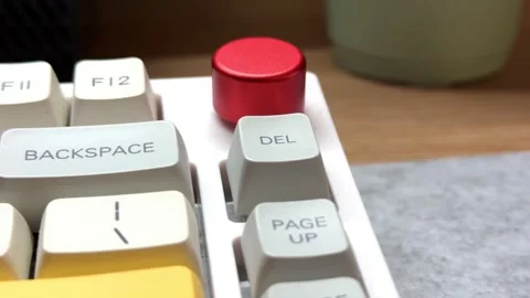 White mechanical keyboard in the office of a programmer employee with big red Stock Footage 302719108