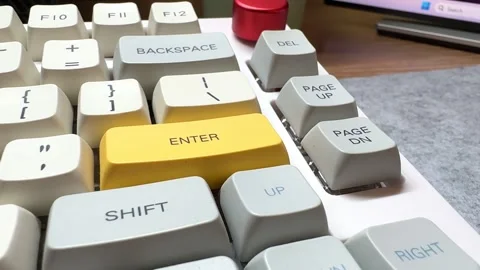 White mechanical keyboard in the office of a programmer employee with big yellow Stock Footage 306124521