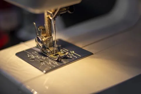 White mechanical sewing machine in the dark. Stock Photos