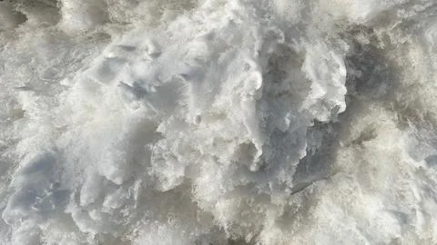 White melting snow texture with ice crystals and frozen water surface as a se Stock Photos
