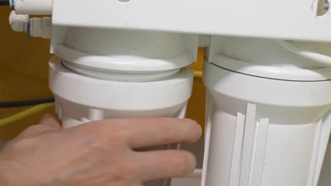 White men hands remove lid of white drinking water filter body with old filter Video stock 126208920