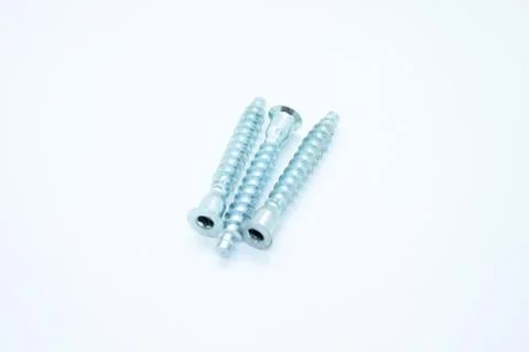 White metal screws located on a white background Stock Photos