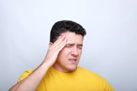 White middle-aged man with closed eyes, touches the head with one hand Stock Photos
